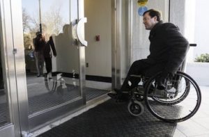 In this figure we observe a wheelchair user entering an accessible door entrance independently
