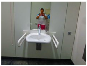 in this figure we observed washbasin mounted at accessible height with U-shape moveable grab bars are present on both the sides and clear knee space under the washbasin.